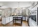 Bright kitchen featuring stainless appliances, light cabinetry, granite countertops, and large windows overlooking the yard at 2125 Fairfax Dr, Alpharetta, GA 30009
