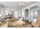 Spacious living room area with hardwood floors, arched entryways, and an open view to kitchen and breakfast nook at 2125 Fairfax Dr, Alpharetta, GA 30009