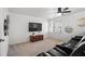 Relaxing living area with a ceiling fan, plush black leather seating, a flat-screen TV, and neutral carpet at 2125 Fairfax Dr, Alpharetta, GA 30009