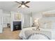 Bright and modern bedroom with fireplace, ceiling fan, carpet, and white bedding at 2125 Fairfax Dr, Alpharetta, GA 30009