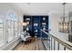 Sitting area with chair, shelving, a chandelier, arched windows and a view of the staircase at 2125 Fairfax Dr, Alpharetta, GA 30009