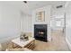Sitting room with fireplace, neutral ottoman and chair, ceiling fan and access to main bedroom at 2125 Fairfax Dr, Alpharetta, GA 30009