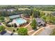 An aerial view of the community pool, tennis courts, and surrounding greenery at 347 Woodridge Pass, Canton, GA 30114
