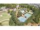 Aerial view showcasing community amenities: a pool, tennis courts, basketball court and clubhouse nestled among lush trees at 347 Woodridge Pass, Canton, GA 30114