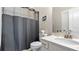 Well-lit bathroom featuring a vanity with solid surface top, and shower with curtain at 347 Woodridge Pass, Canton, GA 30114