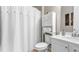 Well-lit bathroom with a shower curtain, white cabinets, and modern fixtures at 347 Woodridge Pass, Canton, GA 30114