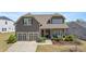 Charming two-story home with a well-manicured lawn, two-car garage, and inviting front porch at 347 Woodridge Pass, Canton, GA 30114