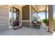 Covered front porch with seating, stone pillars and charming details, perfect for enjoying the outdoors at 347 Woodridge Pass, Canton, GA 30114