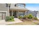 Inviting front porch with stone accents and professionally landscaped garden in front of a lovely two-story home at 347 Woodridge Pass, Canton, GA 30114