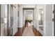 Inviting hallway with hardwood floors and an elegant rug, leading to a bright and airy living space at 347 Woodridge Pass, Canton, GA 30114