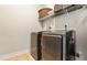 Convenient laundry room features a modern washer and dryer set and overhead storage at 347 Woodridge Pass, Canton, GA 30114