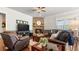 Cozy living room with a stone fireplace, hardwood floors, and comfortable seating at 347 Woodridge Pass, Canton, GA 30114