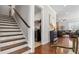 Open-concept living space showcasing hardwood floors, staircase, and seamless flow into other rooms at 347 Woodridge Pass, Canton, GA 30114