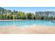Outdoor swimming pool with lifeguard stand, surrounded by lounge chairs and lush trees at 347 Woodridge Pass, Canton, GA 30114