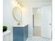 Charming bathroom with a blue vanity, gold hardware, patterned tile floor, and an open doorway at 3554 Cherry Bloom Way, Decatur, GA 30034