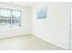 Bright bedroom featuring light wood flooring, a window, white walls, and an entry door at 3554 Cherry Bloom Way, Decatur, GA 30034