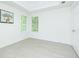 Bright bedroom featuring a tray ceiling, two windows, light wood flooring, and white walls at 3554 Cherry Bloom Way, Decatur, GA 30034