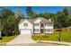 Charming two-story home featuring a well-manicured lawn and inviting curb appeal at 3554 Cherry Bloom Way, Decatur, GA 30034