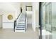 Bright foyer featuring sleek floors, a modern staircase, and an elegant glass front door at 3554 Cherry Bloom Way, Decatur, GA 30034
