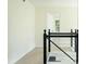 Upstairs hall with modern railing, natural light, and open door at 3554 Cherry Bloom Way, Decatur, GA 30034
