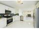 Spacious kitchen featuring stainless steel appliances, white cabinets, and a view of the living room at 3554 Cherry Bloom Way, Decatur, GA 30034