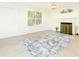 Open living room with fireplace and large area rug at 3554 Cherry Bloom Way, Decatur, GA 30034