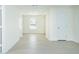 Bright living room with light wood flooring, white walls and doors, and a view through a window at 3554 Cherry Bloom Way, Decatur, GA 30034