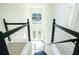 Modern staircase showcasing high ceilings, a statement window, and stylish black metal railings at 3554 Cherry Bloom Way, Decatur, GA 30034