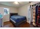Cozy bedroom featuring hardwood floors and a comfortable queen-size bed with a stylish headboard at 4699 Ballew Dr, Powder Springs, GA 30127