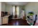 Bright bedroom features hardwood floors and a large window with natural light at 4699 Ballew Dr, Powder Springs, GA 30127