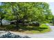 Well-maintained front yard with a mature shade tree that adds to the property's curb appeal at 4699 Ballew Dr, Powder Springs, GA 30127
