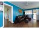 Comfortable living room featuring hardwood floors, a plush sofa, and ample lighting at 4699 Ballew Dr, Powder Springs, GA 30127
