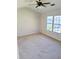 Light-filled bedroom featuring a ceiling fan and large windows at 528 Lantern Wood Dr, Scottdale, GA 30079