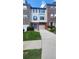 A charming townhome with brick and vinyl siding, a one-car garage, and a well-manicured lawn at 528 Lantern Wood Dr, Scottdale, GA 30079
