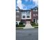 A charming townhome with brick and vinyl siding, a one-car garage, and a well-manicured lawn at 528 Lantern Wood Dr, Scottdale, GA 30079