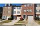 Exterior view of townhomes featuring garages, yards and driveways at 528 Lantern Wood Dr, Scottdale, GA 30079