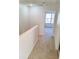 Hallway with neutral carpet leads to a bright room at 528 Lantern Wood Dr, Scottdale, GA 30079