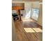 Bright kitchen features stainless steel appliances, wood cabinets and flooring, and lots of natural light at 528 Lantern Wood Dr, Scottdale, GA 30079