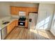Modern kitchen with stainless steel appliances, granite countertops, wood cabinets and flooring at 528 Lantern Wood Dr, Scottdale, GA 30079