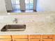 Modern kitchen with breakfast bar and granite countertop and a stainless steel sink at 528 Lantern Wood Dr, Scottdale, GA 30079