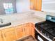 Modern kitchen features stainless steel appliances, granite countertops, and wood cabinets at 528 Lantern Wood Dr, Scottdale, GA 30079