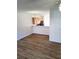 Open-concept living area with stylish wood floors and a partial view of the modern kitchen at 528 Lantern Wood Dr, Scottdale, GA 30079