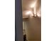 Staircase with a modern light fixture and neutral-colored walls, leading to another level at 528 Lantern Wood Dr, Scottdale, GA 30079