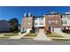 Attractive brick and siding townhomes with well-manicured lawns and individual driveways at 528 Lantern Wood Dr, Scottdale, GA 30079