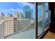 The balcony showcases panoramic views of the city skyline with floor-to-ceiling windows and ample sunlight at 860 Peachtree Ne St # 1010, Atlanta, GA 30308