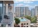 Balcony view featuring a pool with lounge chairs and a vibrant city landscape, perfect for relaxation at 860 Peachtree Ne St # 1010, Atlanta, GA 30308
