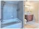 Bright bathroom with a tiled shower-tub combo and a matching vanity with granite counters at 860 Peachtree Ne St # 1010, Atlanta, GA 30308