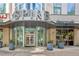 Upscale building entrance with revolving doors, planters, and clear signage at the Spire Condominiums at 860 Peachtree Ne St # 1010, Atlanta, GA 30308