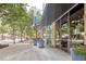 Building exterior with flower planters and trees along the sidewalk at 860 Peachtree Ne St # 1010, Atlanta, GA 30308
