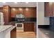 Kitchen featuring stainless steel appliances, granite countertops, and dark wood cabinets at 860 Peachtree Ne St # 1010, Atlanta, GA 30308